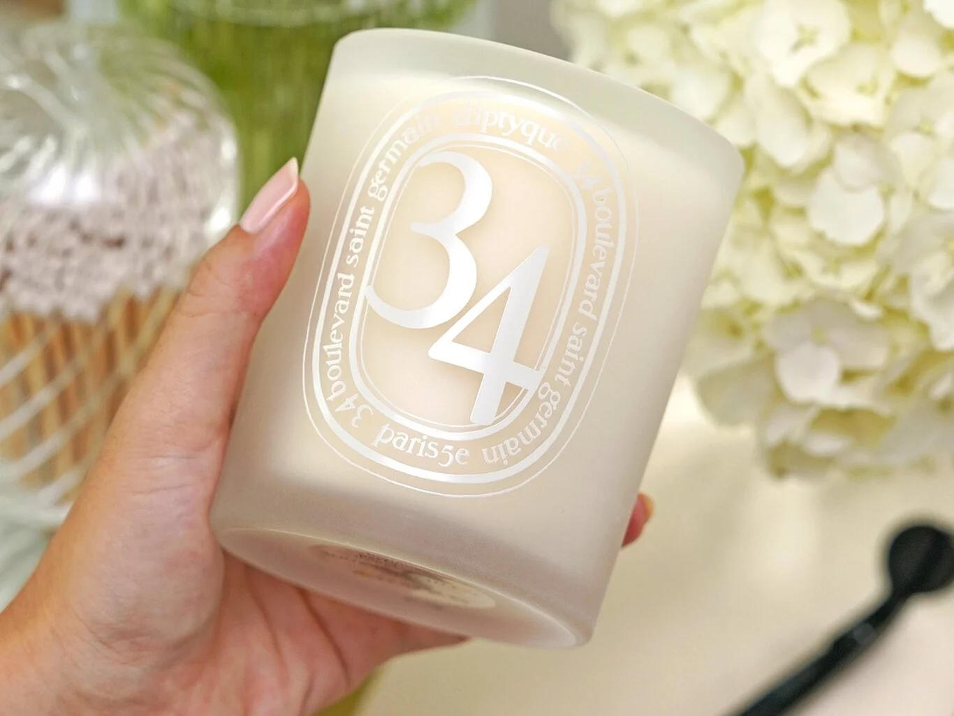 Diptyque 34 Boulevard Saint Germain candle with a unique blend of woody, spicy, and floral notes in a sophisticated glass jar