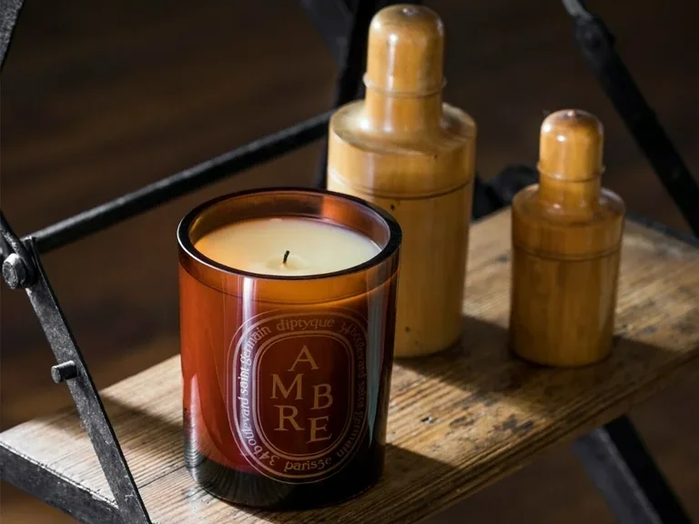 Diptyque Ambre candle with a deep, spicy amber fragrance featuring hints of vanilla and patchouli in an elegant glass jar