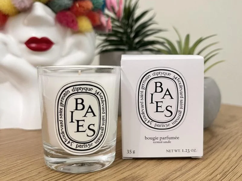 Diptyque Baies candle displayed with its elegant packaging, showcasing luxury and sophistication.