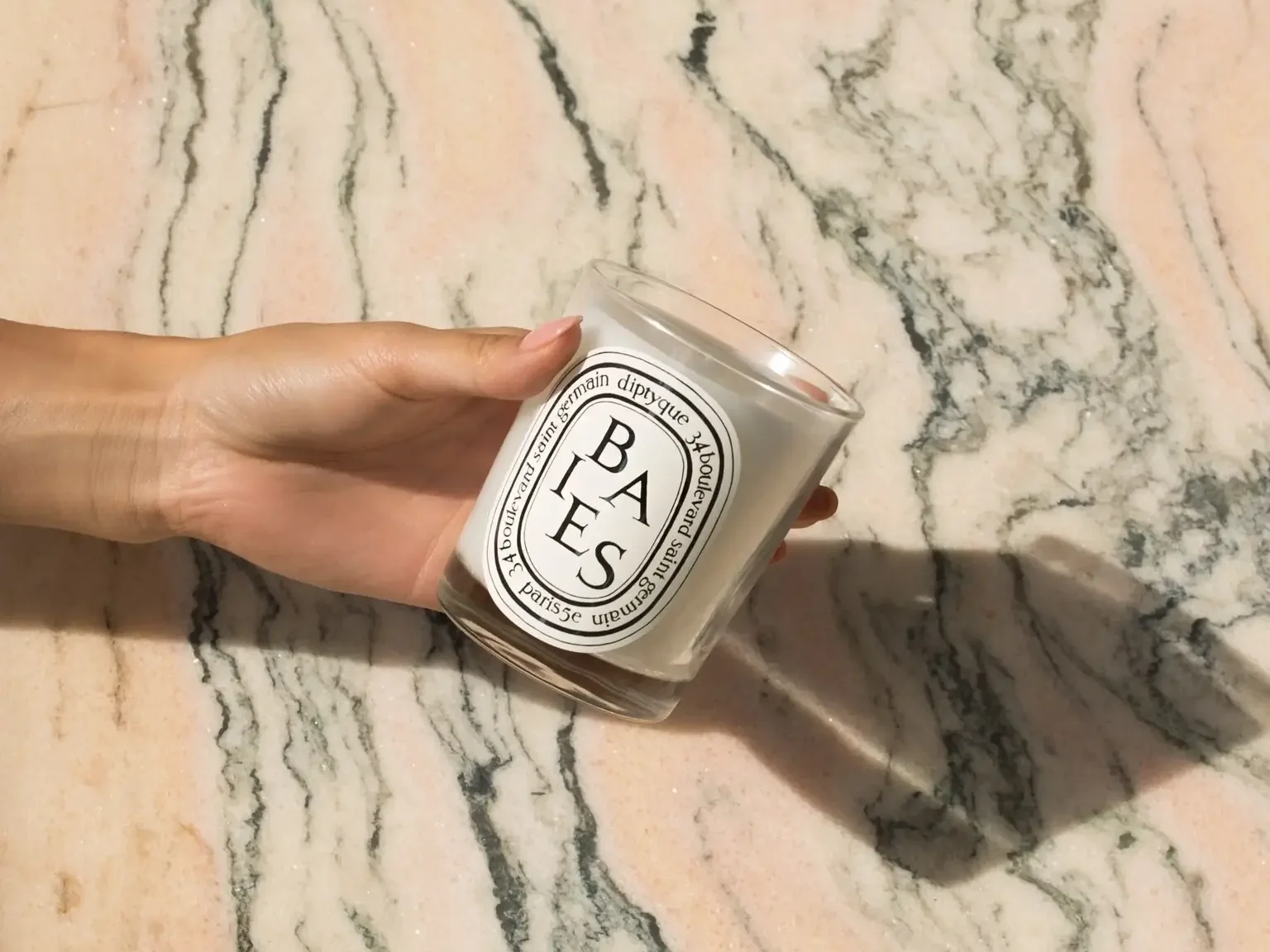 Diptyque Baies candle in 2024, featuring the luxurious blend of blackcurrant berries and Bulgarian roses in an elegant glass jar