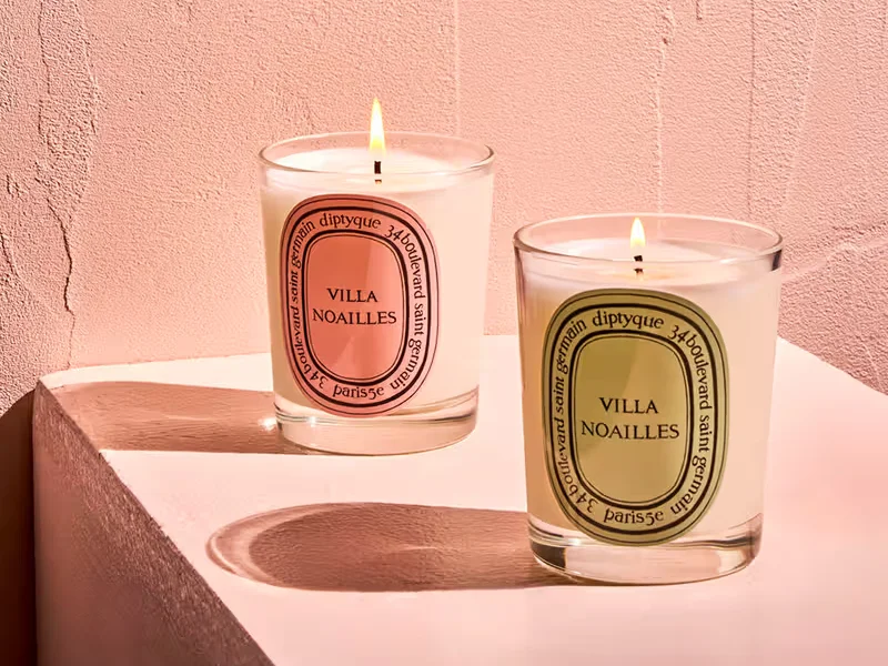 Two Diptyque candles placed together, demonstrating effective usage for optimal fragrance release