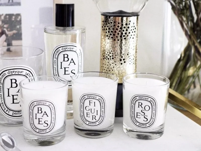 Factors to consider when choosing a Diptyque candle in 2024, including fragrance, burn time, and jar design for top candles like Baies and Feu de Bois